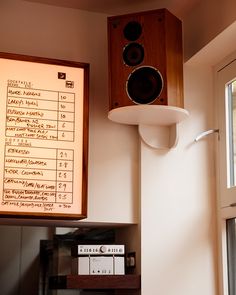 the speakers are hanging on the wall above the table