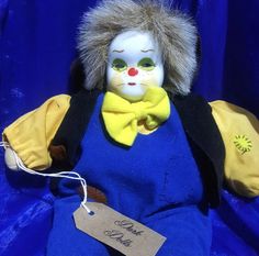 a stuffed animal with a tag on it's chest and ear is sitting in front of a blue background