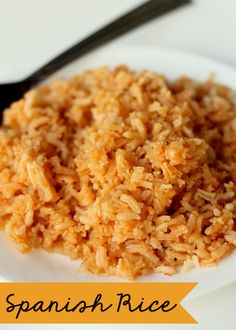 a white plate topped with rice and a fork