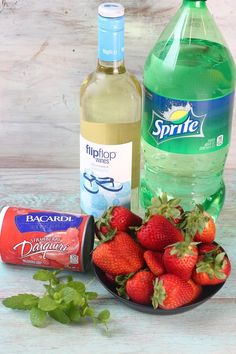 some strawberries are on a plate next to a bottle of water and an ice cream