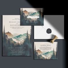 wedding stationery with mountains and trees on it