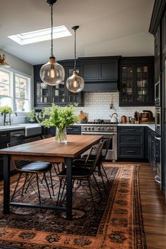 a kitchen with black cabinets and an area rug on the floor that has a wooden table in it