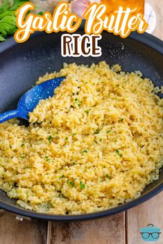 garlic butter rice in a skillet with a blue spoon and parsley on the side