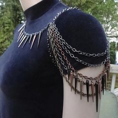 This edgy shoulder chain is made with darker shades of chains and three sized spikes. Chain colors are gunmetal, hematite, antiqued copper and bronze. Spike colors are gunmetal, copper, silver, black, bronze and gold. The neck chain has lobster claw clasps on each side making the piece very versatile by making it able to be worn 4 different ways. You can wear it on the right side or the left side and you can change the spiked neck around so you can wear the spikes in the front or in the back. Th Aesthetic Chain Necklace, Edgy Wedding Jewelry, Black And Gold Clothes, Chains Outfit, Types Of Necklaces, Gunmetal Necklace, Claw Jewelry, Chain Shirt, Shoulder Jewelry