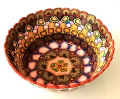 three colorful bowls sitting on top of a white table