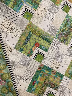 a patchwork quilt with many different designs on it