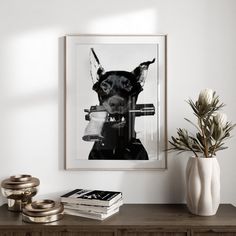 a black and white photo of a dog on a wall above a table with books