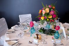 the table is set with flowers and wine glasses for an elegant wedding reception or special event