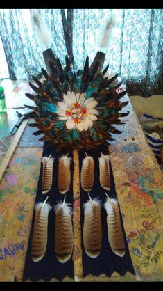 an arrangement of feathers is sitting on a table