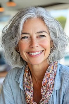 Save this pin for the best short gray hairstyles for women over 60. This chic wavy bob has soft waves that provide movement and body, perfect for women with fine or thinning hair. The chin-length cut is easy enough to maintain yet versatile enough to style differently day-to-day. Wavy Gray Hairstyles, Chin Length Grey Hair, Chin Length Grey Hair Over 50, Short Wavy Gray Hair Over 50, Grey Wavy Bob Hairstyles, Chin Length Grey Hair With Bangs, Wavy Gray Hair Over 50 Bob Hairstyles, Short Wavy Hairstyles For Women Over 60 Grey Hair, Short Gray Hairstyles