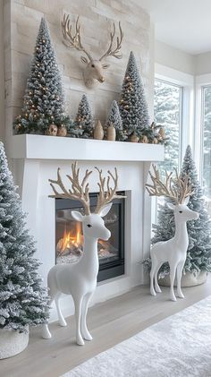 a fireplace decorated with christmas trees and deer statues