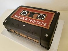 a cake made to look like an old school cassette tape recorder with the words adre's mix tape on it