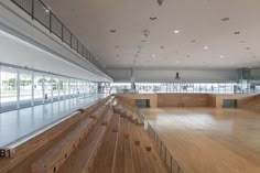 an empty dance hall with wooden floors and large glass windows on the wall to let in light