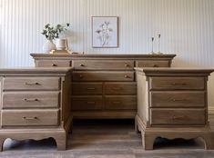 a wooden desk with drawers and a vase on top