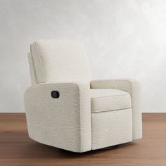 a white recliner chair sitting on top of a wooden floor