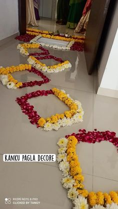 flower garlands laid out on the floor in front of a mirror