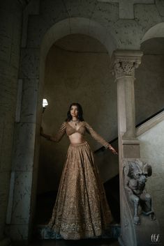 a woman in a long dress standing on stairs