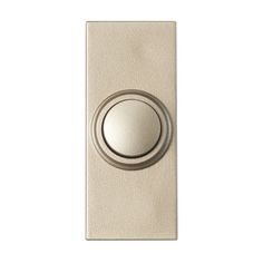 a light switch with a metal button on the front and side of it's cover