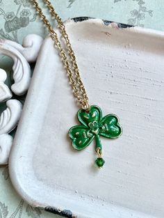 The combination of the Claddagh and the shamrock in a single pendant creates a meaningful and remarkable symbol that represents both loyalty to Ireland and Irish faith. The Claddagh is traditionally associated with love, loyalty, and friendship, while the shamrock symbolizes Ireland and the holy trinity. The brass pendant has been hand-enameled in green, which is often associated with Ireland and its rich landscapes. The green enamel adds a vibrant and visually appealing element to the pendant, Traditional Irish Jewelry, Clover Locket, Shamrock Jewelry, Vintage Shamrock, 4leaf Clover Necklace, Irish Necklace, Claddagh Necklace, Clover Necklace, Irish Heritage