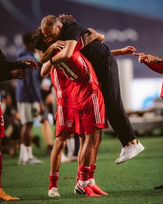 two soccer players are hugging each other on the field