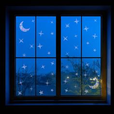 a window with stars and the moon seen through it