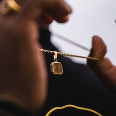 The Tigers Eye Pendant. Created using real cuts of a Tigers Eye Gemstone. Every stone is unique making it the perfect necklace for your unique style.  Also available in Silver. DETAILS Pendant size: 1.5cm x 1.5cm  Chain styles: Rope (2.5mm) Materials: Stainless Steel / 18K Gold PVD Plating Necklace clasp: Lobster Packed in a Twistedpendant Jewellery Pouch Hypoallergenic Tigers Eye Gemstone SIZING This chain is available in lengths: 20", 50.8cm  22", 55.8cm  24" 61cm  Model is wearing 22"  If not Good Luck Necklace Men, Luxury Handmade Men's Necklace, Lock Pendant Necklaces Men, Men Tiger Eye Necklace, Rope Chain Gold, Chain With Pendant, Eye Pendant Necklace, Gold Tiger Eye, Necklace Clasp