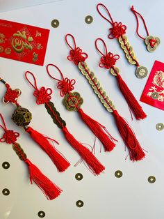 a table topped with lots of tassels and red packets on top of it