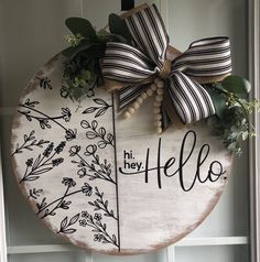 a wooden sign with a bow on it that says hello, he's hello