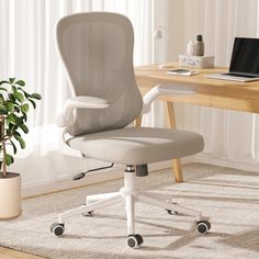 an office chair sitting in front of a desk with a laptop computer on top of it