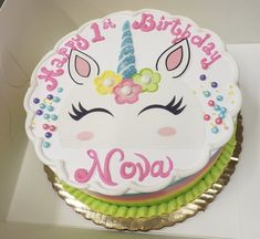 a birthday cake with a unicorn face and name on it's frosted icing