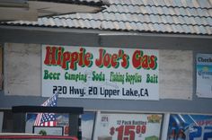 the sign for hippie joe's gas is hanging on the wall next to other signs