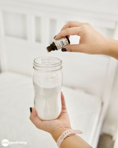 a person is holding a jar with some white stuff in it