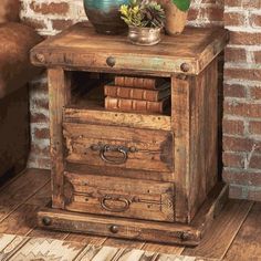 an old wooden table with drawers and a potted plant sitting on top of it