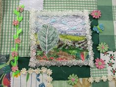 an image of a patchwork quilt with flowers and plants on it's edges