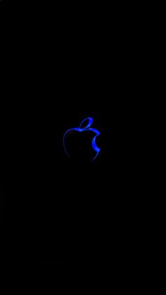 an apple logo is shown in the dark with blue light coming from it's side