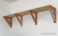 three wooden shelves are hanging on the wall