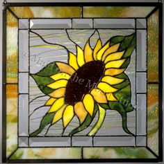 a stained glass window with a sunflower on it