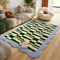 a living room filled with furniture and a rug on top of a hard wood floor