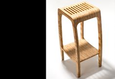 a wooden stool with a slatted design on the top and bottom, against a white background