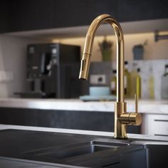 a kitchen sink with a faucet in the middle and an oven behind it