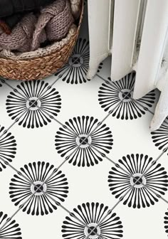 a black and white floor with an umbrella design on it, next to a radiator