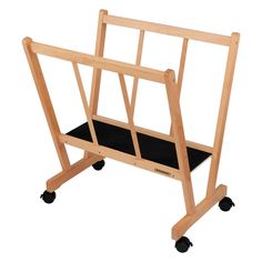 a small wooden rack with wheels and black carpet on the bottom shelf is shown in front of a white background