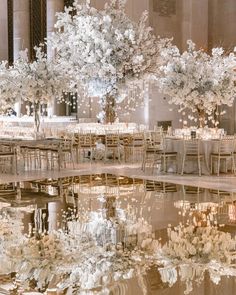 a large room with tables and chairs set up for a formal function in the middle of it