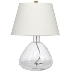 a clear glass table lamp with a white shade