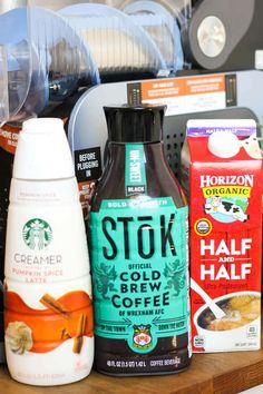 starbucks products are sitting on a shelf in a coffee shop, with other items nearby