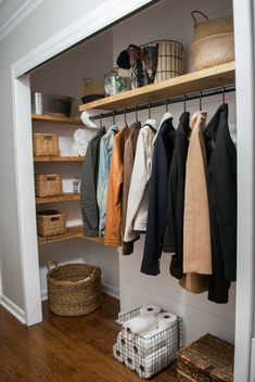 an organized closet with clothes and baskets