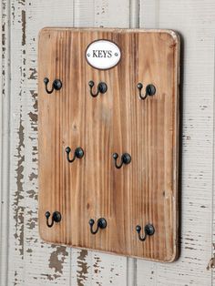 a wooden door with black handles and keys attached to it's sides, on a white background