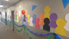 an office hallway decorated with colorful paper cutouts and streamers on the side wall