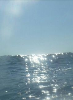 the sun shines brightly on the water as it reflects off the surface of the ocean