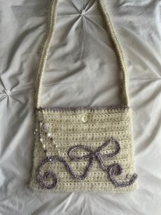 a crocheted purse with the letter s on it